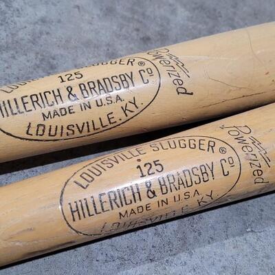 Lot 379: Vintage Pair of Louisville Slugger Wood Baseball Bats (Jackie Robinson and Roberto Clemente) - Robinson has a crack