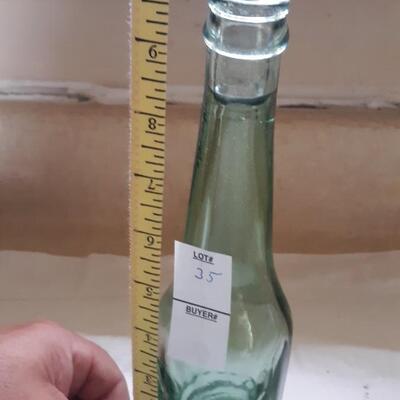 Lot 35 - Tilted Glass Soda Bottle