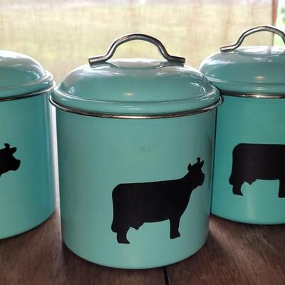 Lot 280: Turquois Cannisters with Cows, Cow Creamer and (2) Nantucket Bread Dishes 