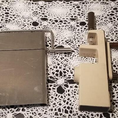Lot 392: Kitchen Cheese Slicer and Handi Magic Hand Mill