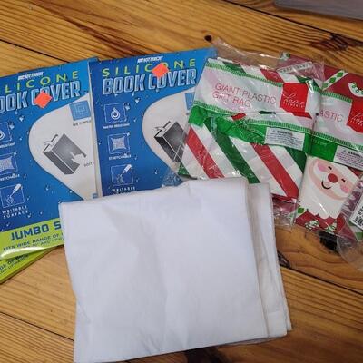 Lot 460: Assortment of Deco Paper and Silicone Book Covers (Plastic Bin included)