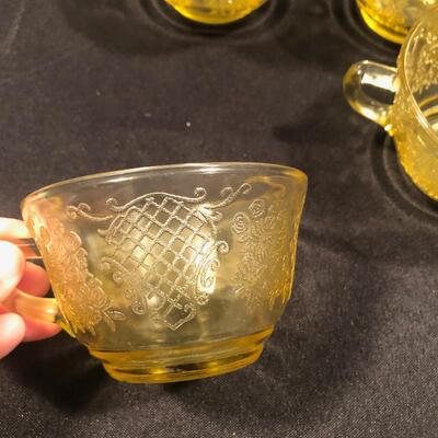 #65 Set of four yellow glass tea cups 