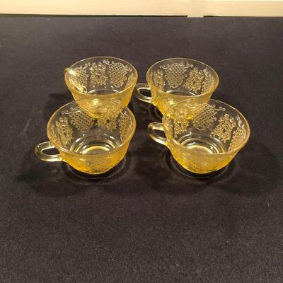 #65 Set of four yellow glass tea cups 