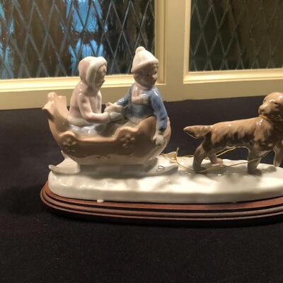 #105 Kids sledding with dog porcelain Figurine