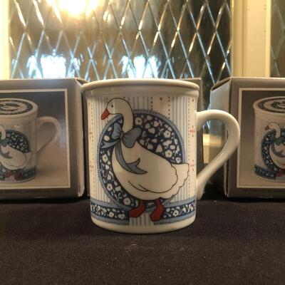 #116- Set of four porcelain covered mug and coaster set. 