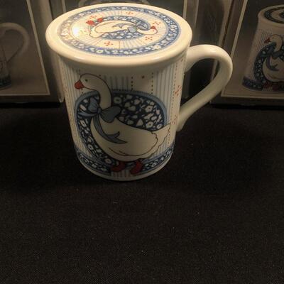 #116- Set of four porcelain covered mug and coaster set. 