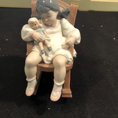 #139- Lladro girl sleeping in a rocking chair
