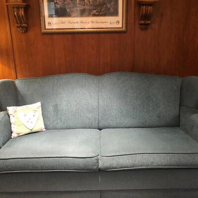 #187- Teal upholstered loveseat excellent condition folds out into bed