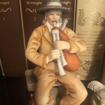 #214 porcelain figurines woman feeding chickens man playing bagpipes
