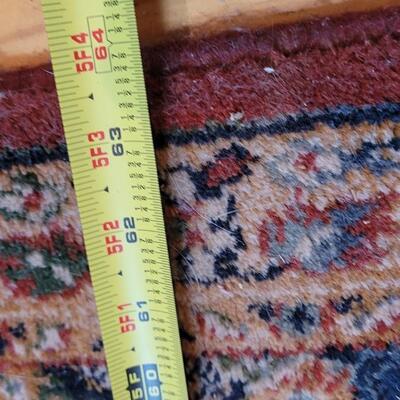 Lot 579: Area Rug- has a spot with wear