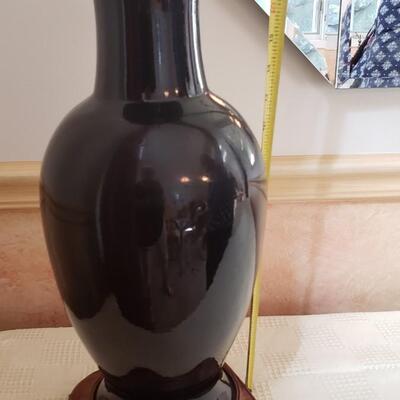 Tall black vase on stand