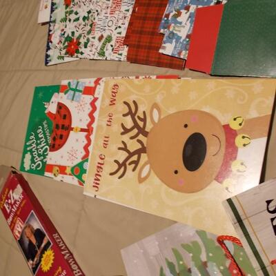 Large collection of holiday boxes, bags, tissue paper, and a bow maker. 