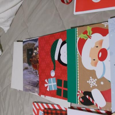 Large collection of holiday boxes, bags, tissue paper, and a bow maker. 