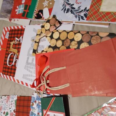 Large collection of holiday boxes, bags, tissue paper, and a bow maker. 