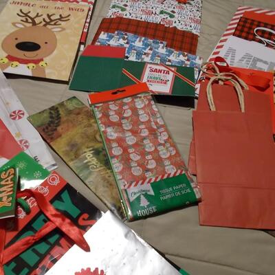 Large collection of holiday boxes, bags, tissue paper, and a bow maker. 