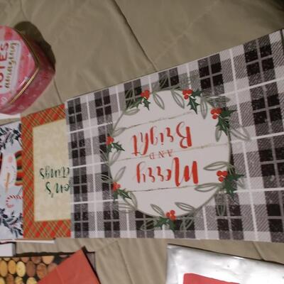 Large collection of holiday boxes, bags, tissue paper, and a bow maker. 