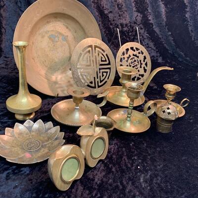 Antique and authentic collection of hand held candle sticks, trivets, etc...