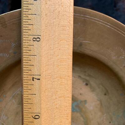 Antique and authentic collection of hand held candle sticks, trivets, etc...