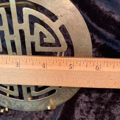 Antique and authentic collection of hand held candle sticks, trivets, etc...