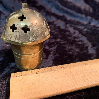 Antique and authentic collection of hand held candle sticks, trivets, etc...