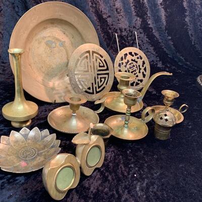 Antique and authentic collection of hand held candle sticks, trivets, etc...