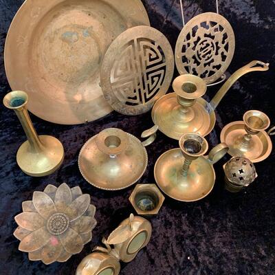 Antique and authentic collection of hand held candle sticks, trivets, etc...