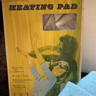 Lot of vintage scale, heating pad, blankets, travel pillow and wedge pillow.