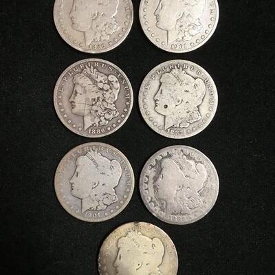 7 Morgan silver dollars .Reserve set