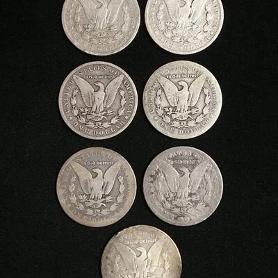 7 Morgan silver dollars .Reserve set