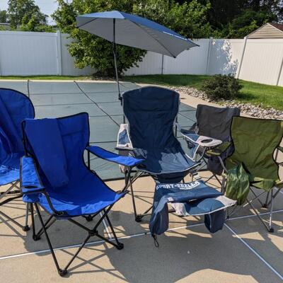 Five folding outdoor chairs with bags