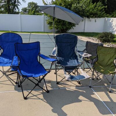 Five folding outdoor chairs with bags