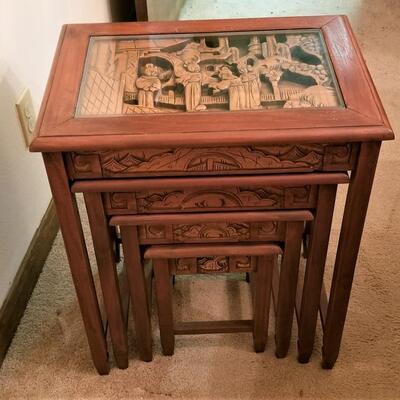 Lot #126  Set of 4 Nesting Tables with Carved Wooden Scenes