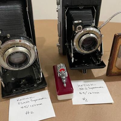 Kodak Folding Pocket Cameras with accessories.