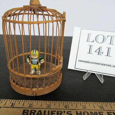 Birdcage With Tiny Packer's Figurine Inside