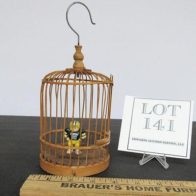 Birdcage With Tiny Packer's Figurine Inside