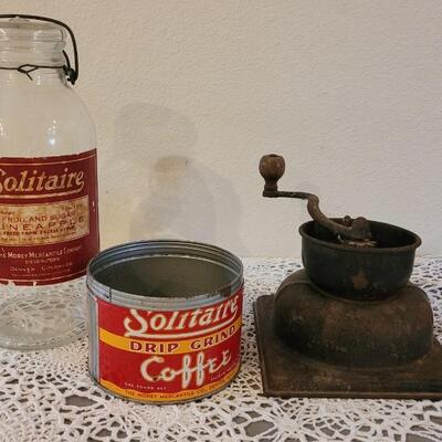 Lot 163: Antique Coffee Grinder, Solitaire Coffee Tin and Fruit & Sugar Pineapple Glass Jar