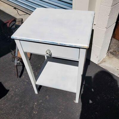 White 1- drawer square end table with bottom shelf.
