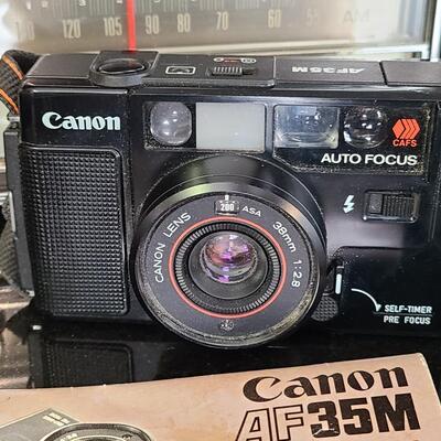 Lot 428: MCM Vintage GE Working Radio, Canon Camera and More