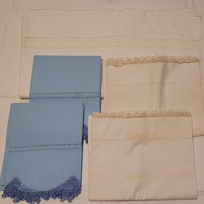 Lot 132: Vintage Handmade Crochet Edge Blue Pillowcases, Eggshell Pillowcases (was tape residue) and (2) White Full Flat Sheet