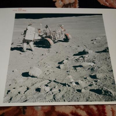 Photograph of Astronaut on and Rover Machine on planet