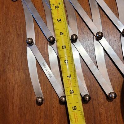 Lot 194: Stainless Platters Serving Bowls and Accordian Hot Pad