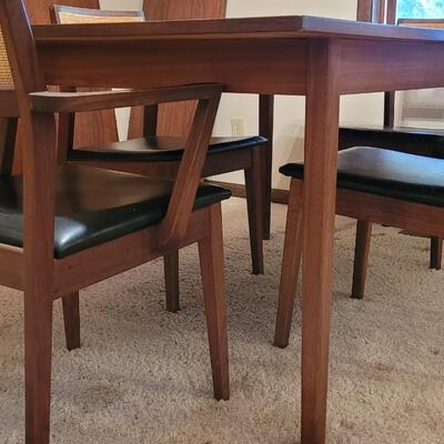 Lot 203: Mid Century Modern FOUNDERS American Walnut Dining Table with 2 Leaves and 4 Black Leather Seat Cane Back Chairs