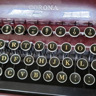 Burgundy or maroon  color Smith Corona manual portable typewriter