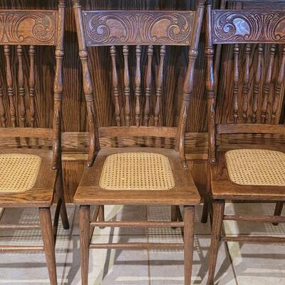 Lot 109: (5) Antique Oak Chairs (4 Cane Seat and one need Repair and comes with Seat Material