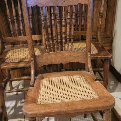 Lot 109: (5) Antique Oak Chairs (4 Cane Seat and one need Repair and comes with Seat Material