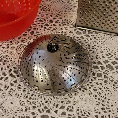 Lot 127: (2) Colanders. Steam Basket and Grater