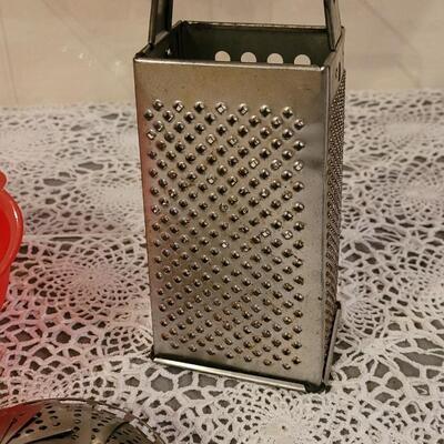 Lot 127: (2) Colanders. Steam Basket and Grater