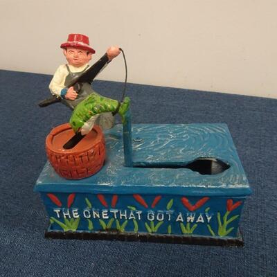 LOT 104.  VINTAGE DIE CAST FISHING METAL BANK