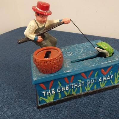 LOT 104.  VINTAGE DIE CAST FISHING METAL BANK
