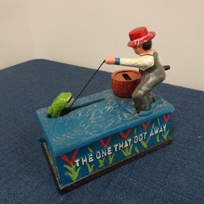 LOT 104.  VINTAGE DIE CAST FISHING METAL BANK